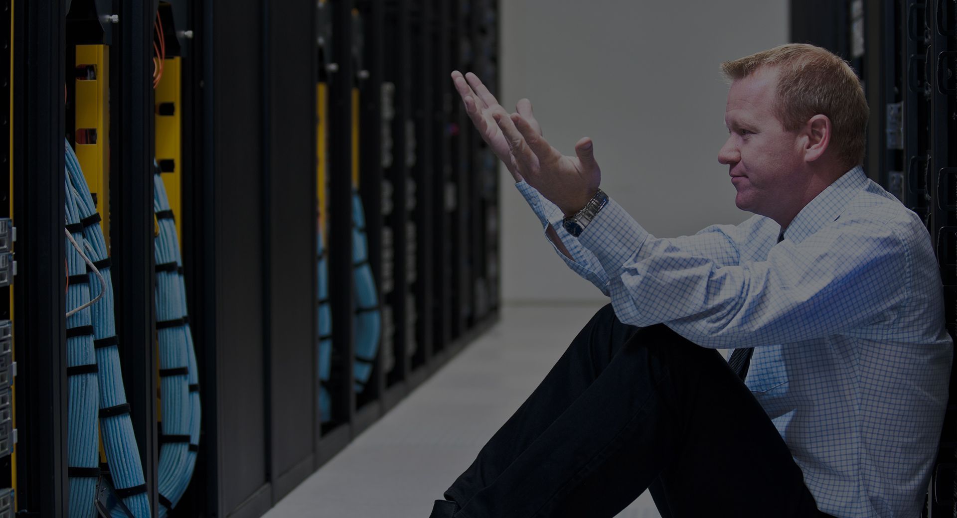 IT network monitoring engineer sitting on floor